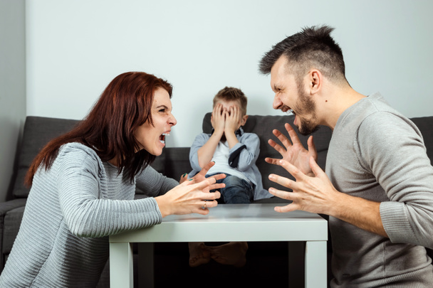 Family quarrel, poma and dad swear in the background of the son who does not like it, the child cries. The concept of family problems, the psyche of the child, domestic violence. - Photo, Image