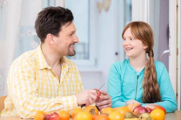 Portrait of happy father and her daughter with fruits - Photo, Image
