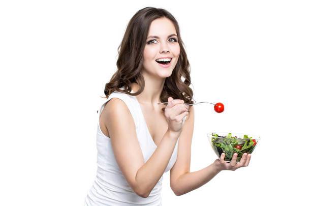 A beautiful girl eating healthy food. Isolated. Healthy lifestyle. - Photo, Image