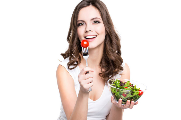 Beautiful girl eating healthy food. Isolated. Healthy lifestyle. - Photo, Image