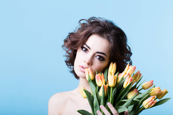 Woman with spring flower bouquet tulips. Springtime. - Foto, Imagen
