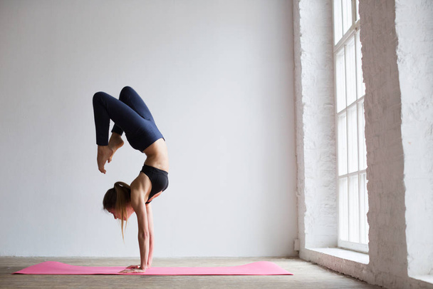 Beautiful sporty yogi girl practices yoga asana. - Zdjęcie, obraz