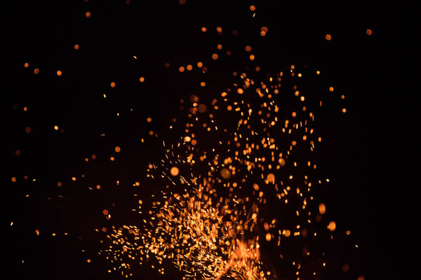 Burning sparks flying. Beautiful flames background. - Photo, image
