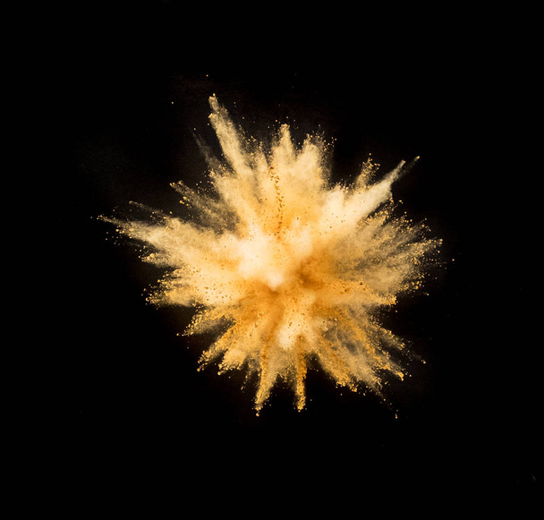 Golden powder explosion on black background. - Photo, Image