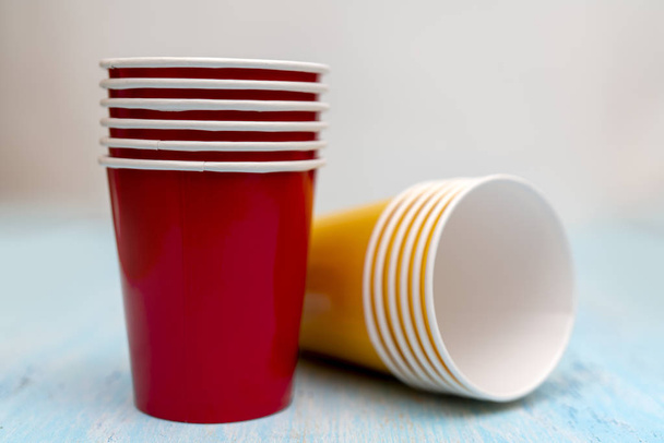 Yellow and red paper disposable cups for drinks. - Photo, Image