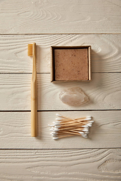 top view of different hygiene and care items on white wooden surface, zero waste concept - Valokuva, kuva