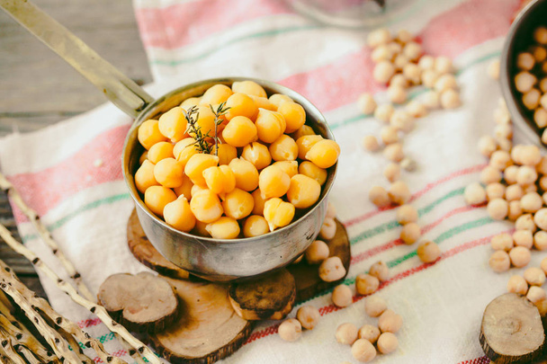 Dried and boiled chickpeas. Vegetarian protein. Dry thyme sprigs in a jar. Healthy lifestyle and balanced food concept. Selective focus. - Photo, Image