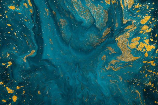 Abstract blue paint background with golden glitter powder  - Photo, Image