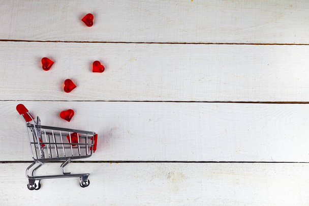 Hearts in the shopping cart on a white background. Shopping for the holiday. - 写真・画像