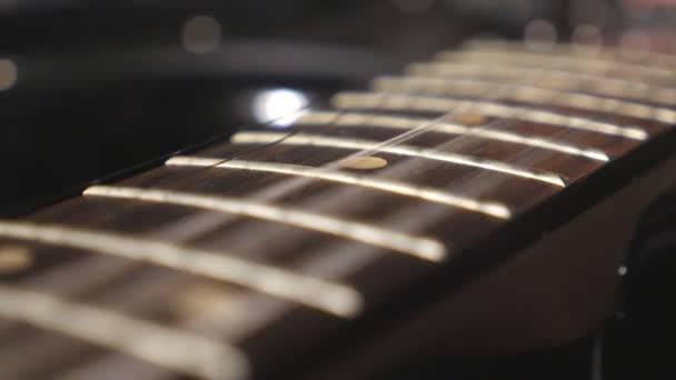Close up of trembling guitar strings against fret. Chords being strummed and vibrating during playing. Beautiful background with wooden texture. Music performance. Blurred motion. Top view Slow motion - Footage, Video