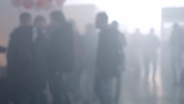 Many people walk in a smoke filled room - Footage, Video