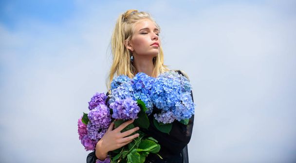 Flowers tender fragrance. Fashion and beauty industry. Girl tender fashion model hold hydrangea flowers bouquet. Makeup and fashion style. Fashion trend spring. Meet spring with new perfume fragrance - Photo, Image