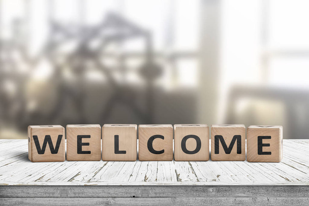 Welcome sign on a table in a lobby with a bright room in the background - Foto, Imagen
