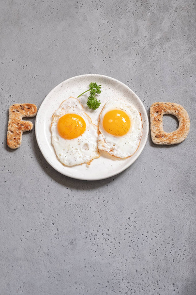 Word food written with toast letters eggs - Foto, imagen
