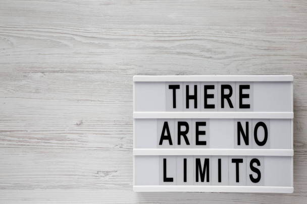Modern board with text 'There are no limits' on a white wooden background, top view. Flat lay, overhead. Copy space. - Photo, Image