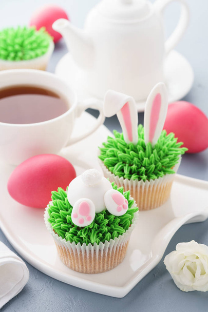 Easter bunny butt and ears cupcakes with eggs and tea for breakfast. - Fotoğraf, Görsel