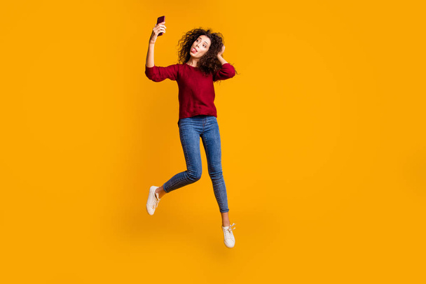 Full length body size view of nice lovely attractive cheerful funny funky comic playful slim thin fit wavy-haired lady taking making selfie having fun isolated on bright vivid shine orange background - Fotoğraf, Görsel