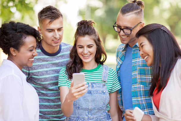 group of happy friends with smartphone outdoors - Photo, image