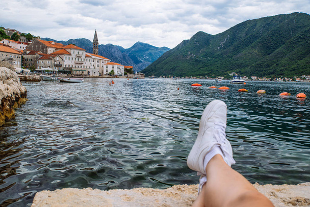 laying at pier with beautiful view of sea with mountains. old european town - Photo, Image