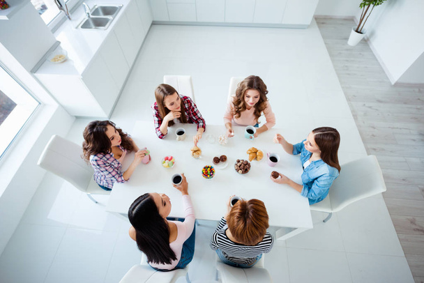 Close up top above high angle view photo beautiful she her ladies group best friends sit round big table bright kitchen hold cups listen rumours news having fun girls day night holiday indoors - Foto, imagen