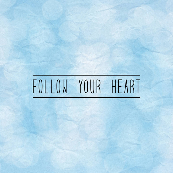 Follow your heart. Inspirational quote on bokeh light with blue crumpled paper. - Fotografie, Obrázek