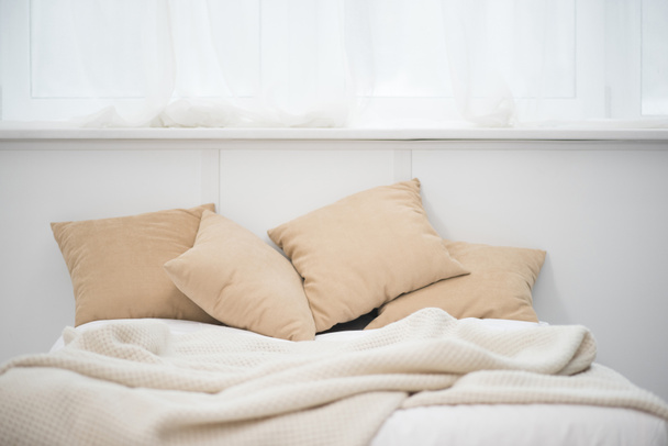 empty bed with brown pillows and white blanket - Fotó, kép