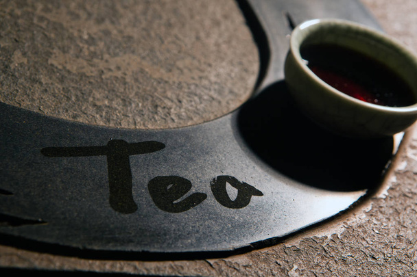 black tea cup text stone background nobody  - Фото, изображение