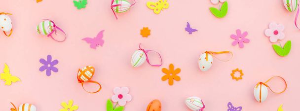Creative Top view flat lay holiday composition Easter eggs spring flowers on pink paper background copy space Template Easter day seasonal pattern - Photo, Image