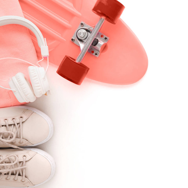 Skateboard and headphones on white background, top view. - Photo, image