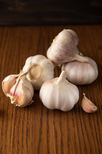 Garlic bulb on the wooden vintage background - Fotó, kép
