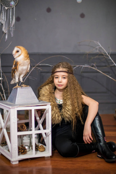Cute girl with long hair with a white owl in her arms in the style of boho  - Foto, Imagen