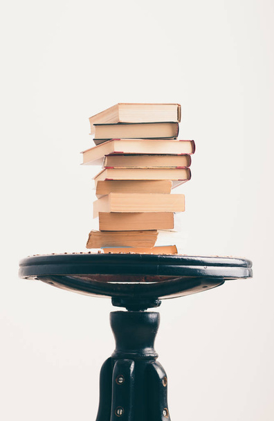 A few books with cup of coffee on chair - Фото, изображение
