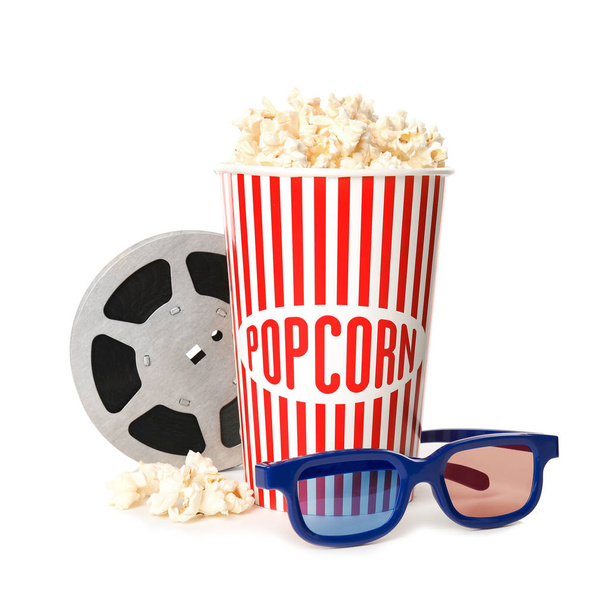 Popcorn, reel and glasses isolated on white. Cinema snack - Photo, image