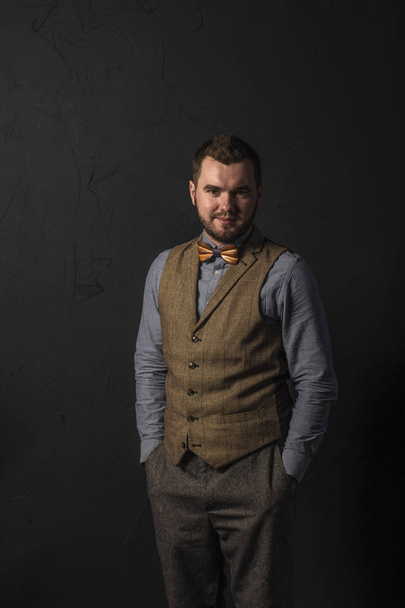 Stylish young man in wooden bowtie. Business style. Fashionable image. Office worker. Sexy man standing and looking at the camera - Fotografie, Obrázek