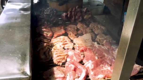 Close up of grilling fresh pork on grill - Felvétel, videó