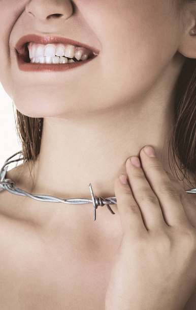 Woman with barbed wire around her throat. Pharyngitis inflammation. - Zdjęcie, obraz