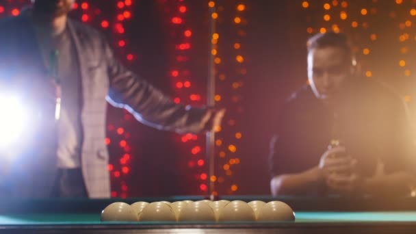 Two men standing by the billiards table and drinking beer - Footage, Video