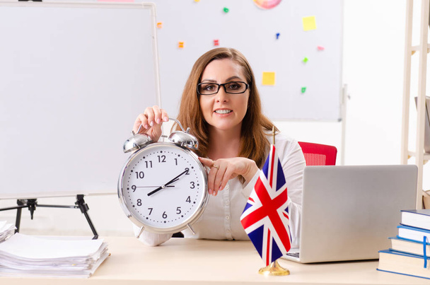 Female english language teacher in time management concept - Photo, Image