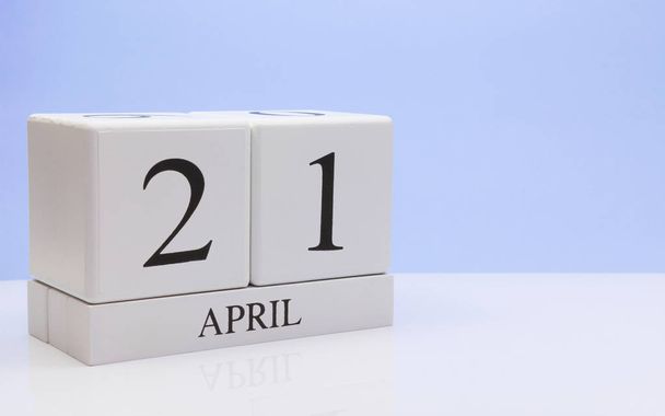 April 21st. Day 21 of month, daily calendar on white table with reflection, with light blue background. Spring time, empty space for text - Photo, image