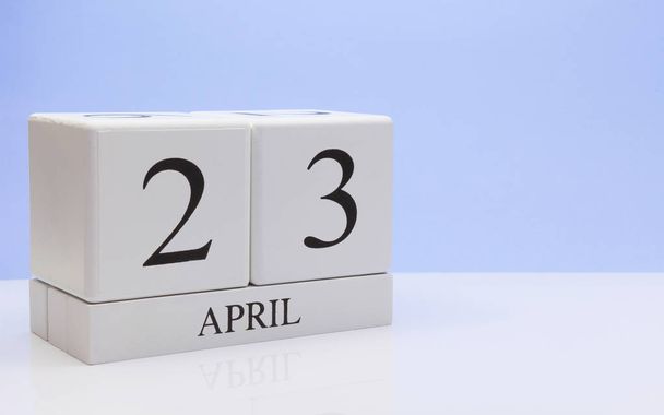 April 23st. Day 23 of month, daily calendar on white table with reflection, with light blue background. Spring time, empty space for text - Valokuva, kuva