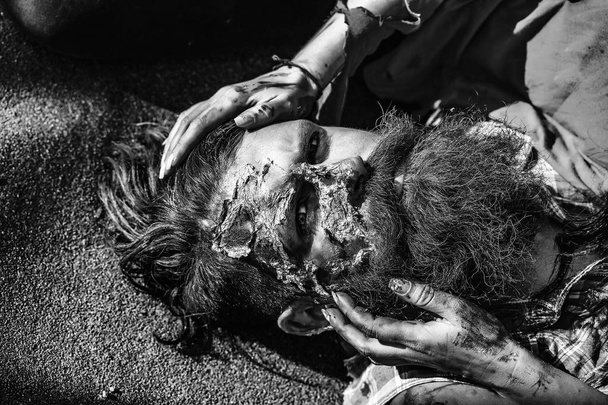Bloody hands hold zombie man - Fotografie, Obrázek