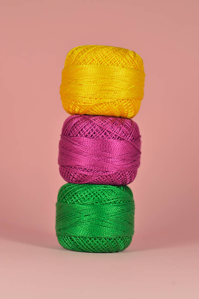 Composition of balls of yarn with pink background for your craft projects. - Photo, image