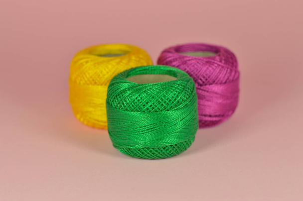 Composition of balls of yarn with pink background for your craft projects. - Photo, image
