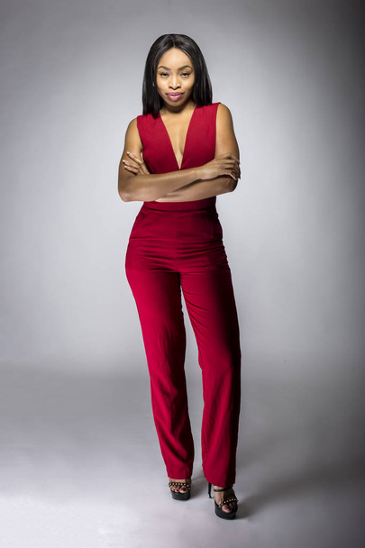 Black African American female model wearing a stylish red casual apparel.  The fashionable outfit looks modern and trendy.  The image depicts shopping and fashion industry. - Fotó, kép