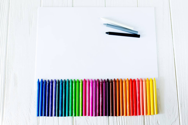 School supplies for drawing on the table: paper and crayons - Photo, image