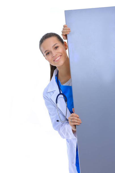 A female doctor with a blank billboard. Woman doctor - Фото, изображение