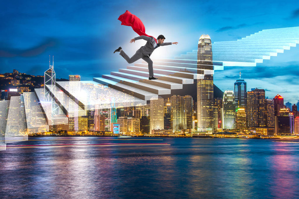 Superhero businessman climbing career ladder - Photo, Image