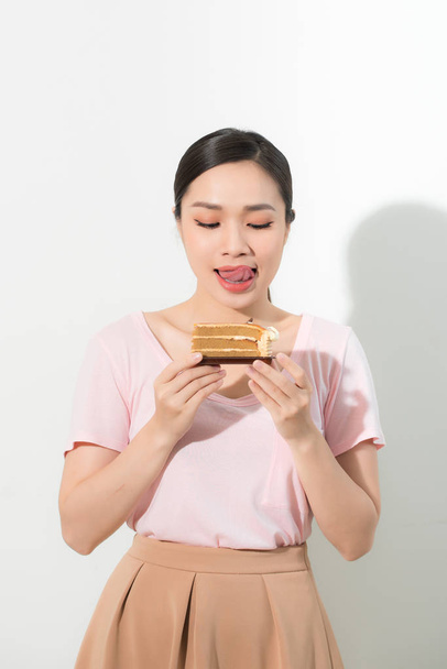beautiful young woman with appetizing cake - isolated on white - Valokuva, kuva