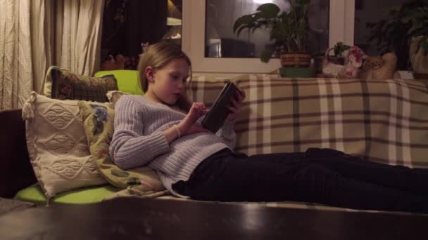 The girl is reading an e-book. - Footage, Video
