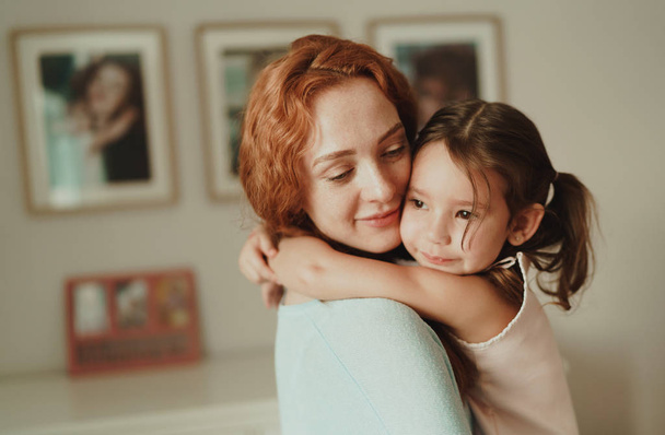 cozy photo session of beautiful happy mother and daughter, indoor - Fotó, kép